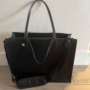 Large black work tote with shoulder strap, laptop case and leather envelope.